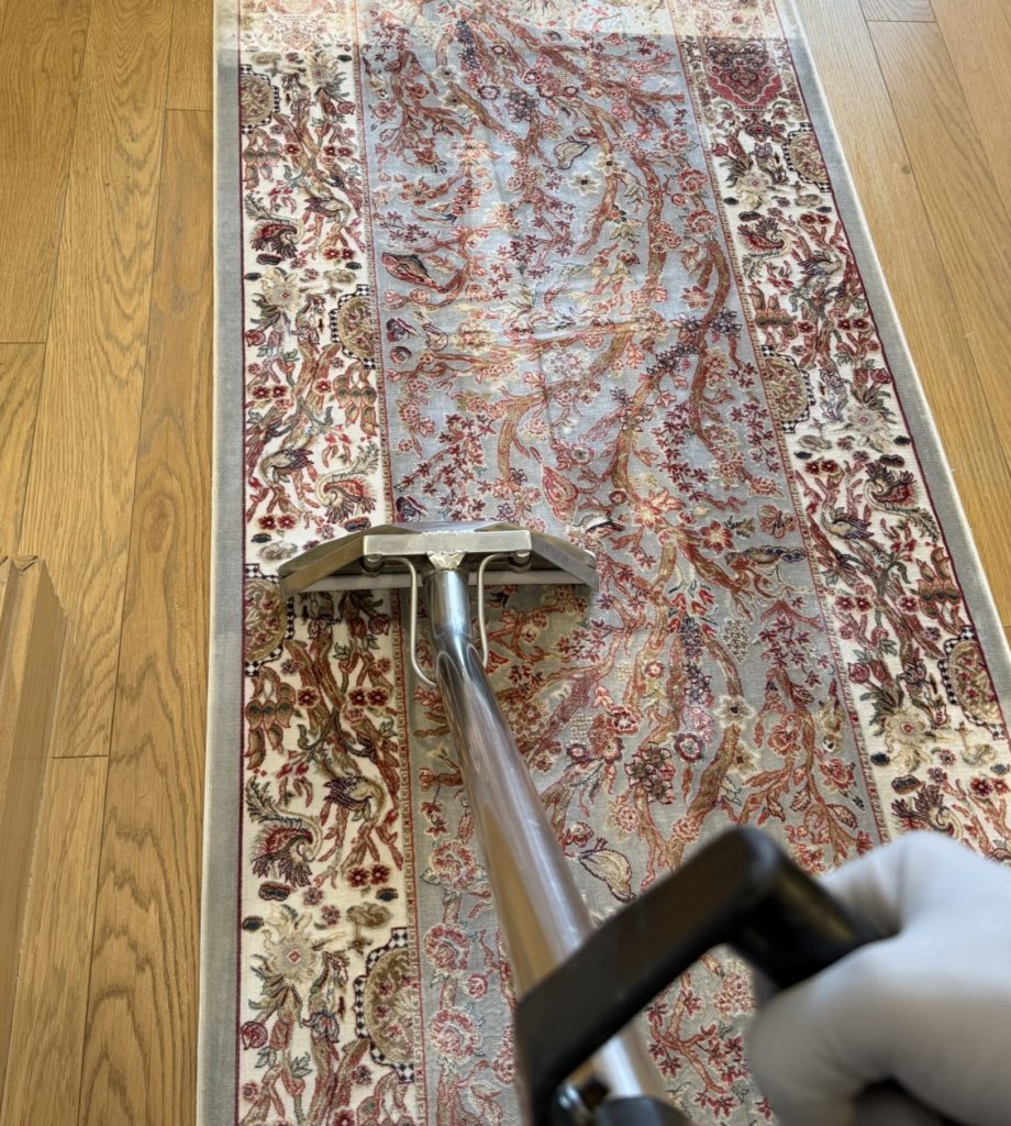 Professional rug cleaning using hot water extraction machine in London
